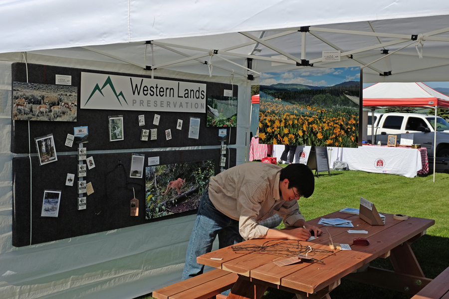 Steven Whitney preparing booth at the Star Valley Street Market event in Afton, Wyoming.